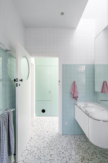 The mint and white tiled bathroom.