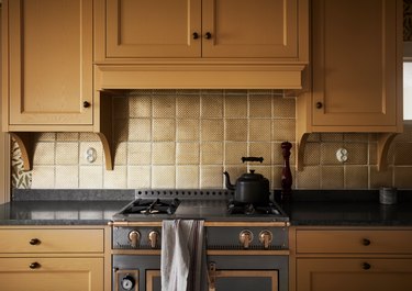 stainless steel stove in yellow kitchen