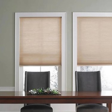 Tan cellular shades in a dining room