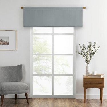 A gray window valance hung over a large window
