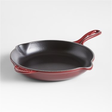 Le Creuset Classic 9" Rhône Enameled Cast Iron Skillet in a dark red color with a gold knob