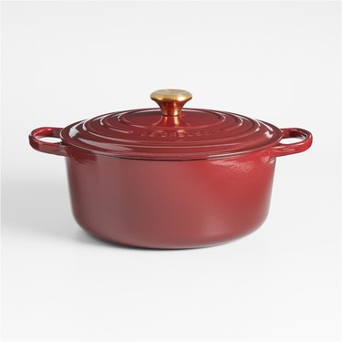 Classic 4.5-Quart Rhône Enameled Cast Iron Dutch Oven in a dark red color with a gold knob