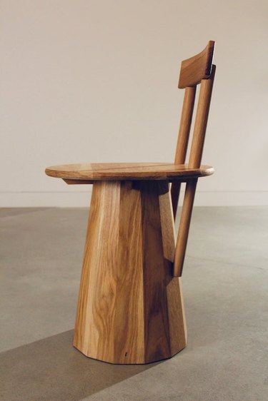 Tiarra Bell's wood Mountain Chair featuring a wide rounded base instead of legs.