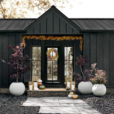black home with wheat garland hung above the threshold