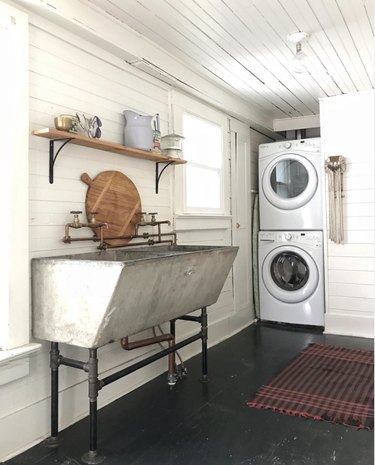 Laundry room with shiplap and concrete sink.