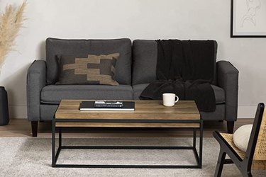 metal and wood coffee table in front of gray couch