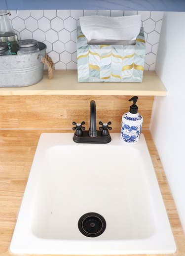 Laundry room sink with drain strainer.