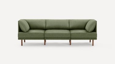Green sofa with wooden accents