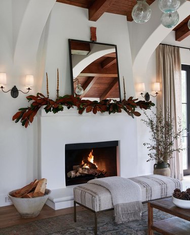 Magnolia garland mantel decoration in white farmhouse living room