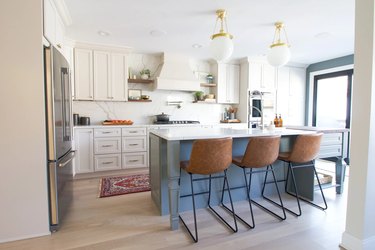 white kitchen cabinets with blue island