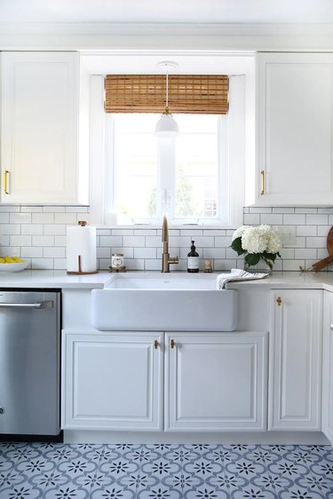 white cabinets with patterned tile floor
