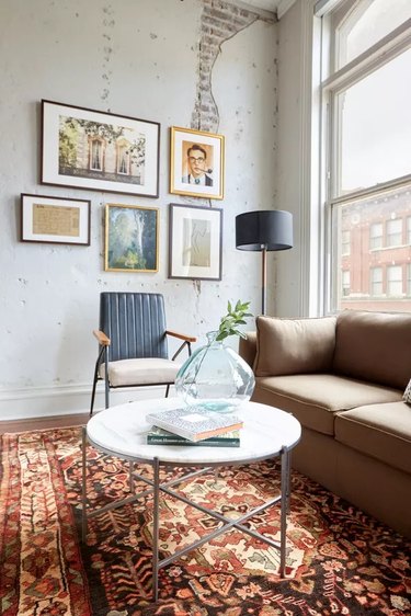 City apartment living room with taupe sofa and vintage area rug