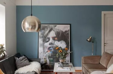 Living room with a gray and a taupe sofa and a blue accent wall