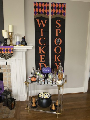 Hocus Pocus themed bar cart with pumpkins and witch hats.