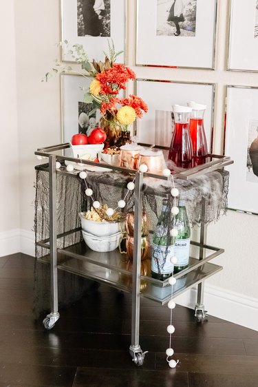 Bar cart with apples and seasonal flowers