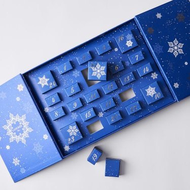 The blue Ladurée Advent Calendar open with 24 boxes all numbered on a white background.