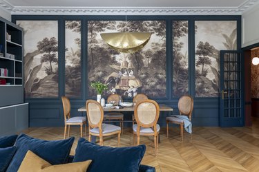 The dining room features scenic wallpaper.