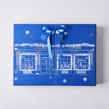 Blue exterior of the Ladurée Advent Calendar with a blue ribbon on a white background.