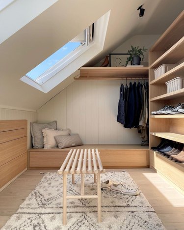 loft space coset with velux skylight and wooden bench