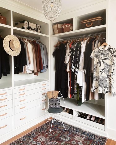 boho walk-in closet with leather pull hardware and textured rug