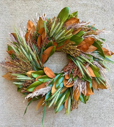 A wreath made from straw and brown and green leaves