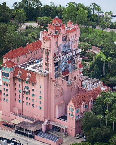 An aerial view of the pink and red Tower of Terror building at Walt Disney World.