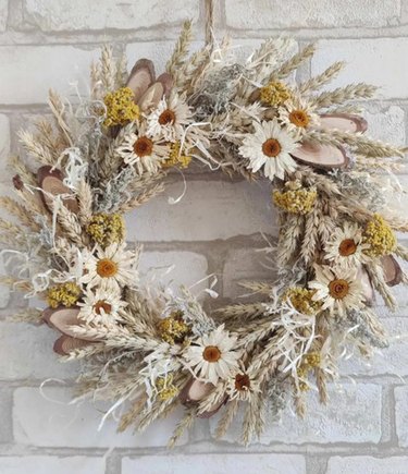 A wreath made from white flowers and straw