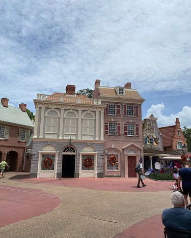 Two colonial-esque buildings with crooked shutters in Liberty Square in Magic Kingdom.