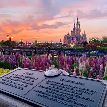 A wide view of the Sleeping Beauty Castle at sunset in the Shanghai Disney Resort.