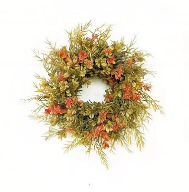 A wreath made from green and orange leaves