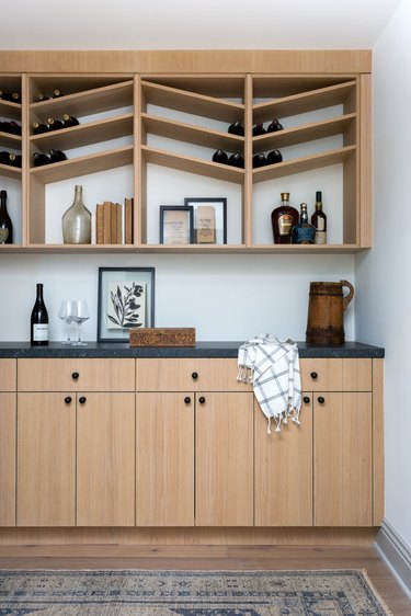 wine room with wood cabinets and storage