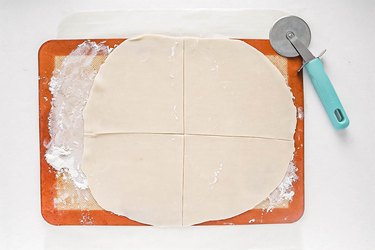 Slice pie dough into four pieces