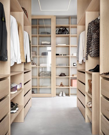 walk-in closet with clothing, shoes, and decor