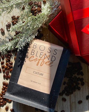 overhead photo of plant and wrapping paper and coffee bag with text that reads "boss blend coffee culture"