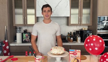 Antoni Porowski behind his specialty Betty Crocker cake for his dog, Neon.