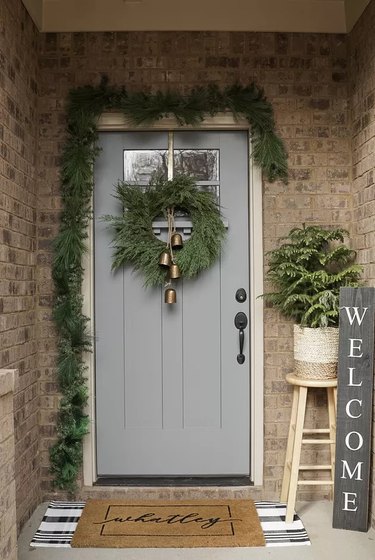 Brown brick porch with a blue-gray front door