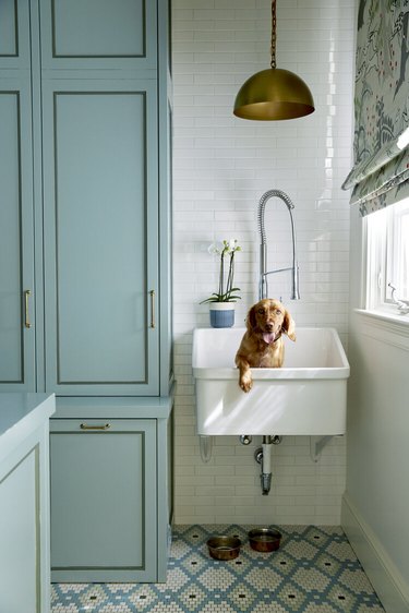 blue and white laundry room with utility sink