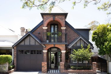 Brown brick house with black trim and garage door