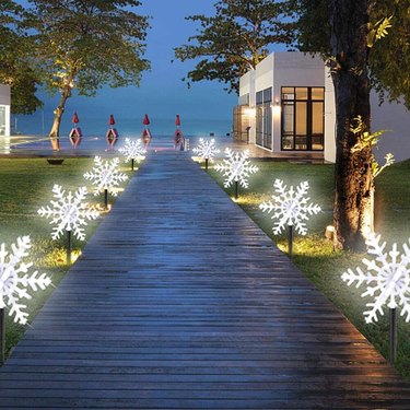 Glowing snowflake decorations light a pathway