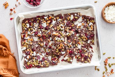 An aerial view of the broken-up chocolate bark on a baking sheet covered in parchment paper.