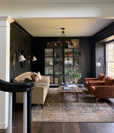 dark living room with brown furniture and decor