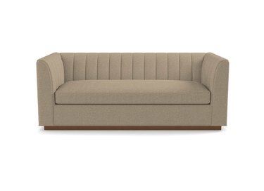 Tan tufted sofa