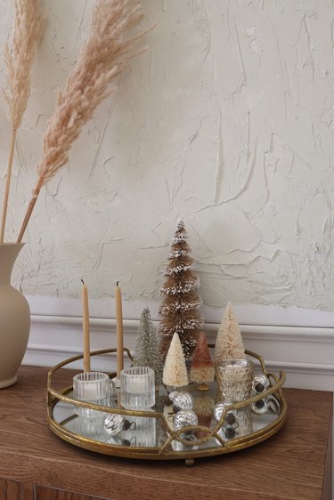 DIY mirrored tray centerpiece with glitter bottle brush trees and mercury glass