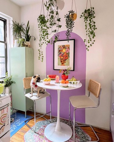 Kitchen dining nook with painted lavender arch and mint green locker cabinet.