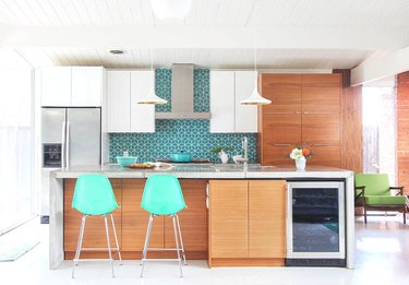 Walnut kitchen cabinets with retro bar stools