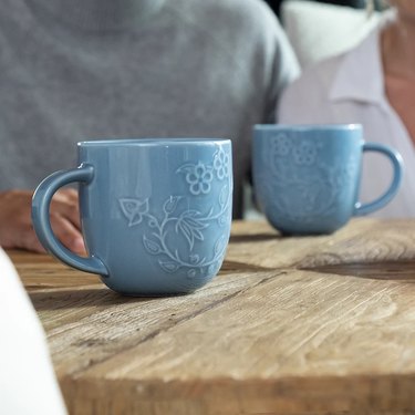 A light blue mug featuring embosses rice blossoms.