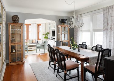 Long wood dining room table with black chairs.