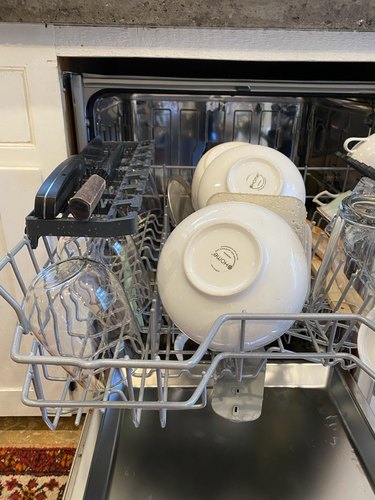 An open Beko dishwasher with the multipurpose service rack in use