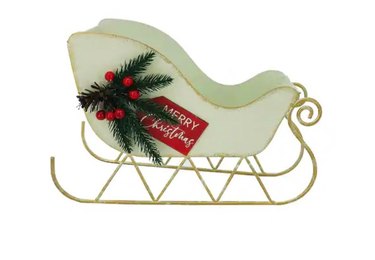 A decorative white sleigh with gold trim. A sprig of red berries and pine is on the side of the sleigh, with a red sign that reads "Merry Christmas"