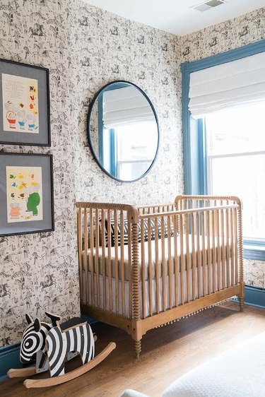 nursery with animal print toile and wood crib